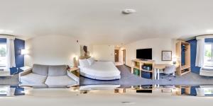 a hotel room with a bed and a tv at Spark by Hilton Milford Boston in Milford