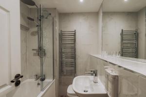 a bathroom with a toilet and a sink and a shower at The Borrowdale Hotel in Keswick +69 photos