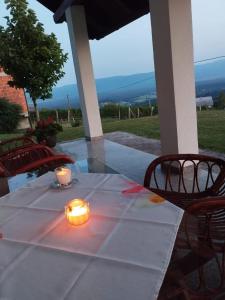 a table with two candles on top of it at Casa Rotti - Countryside Retreat near Krško in Krško