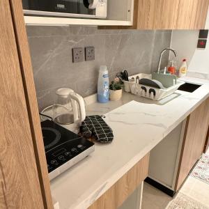 a kitchen counter with a sink and a stove at Bali island Studio in Al Khobar