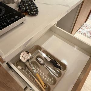 a drawer in a kitchen with utensils in it at Bali island Studio in Al Khobar