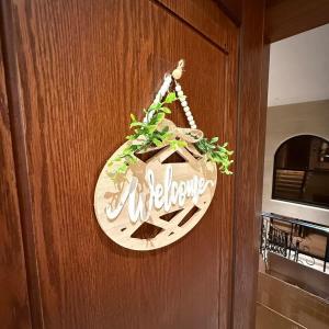 a welcome sign is hanging on a door at Bali island Studio in Al Khobar +25 photos