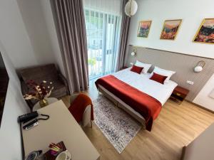 a small hotel room with a bed and a desk at Park Hotel Żywiec in Żywiec +42 photos