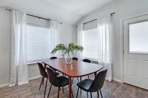 a dining room with a table and chairs and windows at A Serene Oasis! 4-bedrooms! in Saginaw