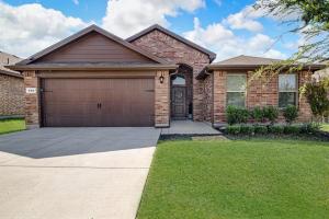a brick house with a garage and a driveway at A Serene Oasis! 4-bedrooms! in Saginaw