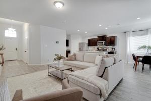 a white living room with a couch and a table at A Serene Oasis! 4-bedrooms! in Saginaw +15 photos