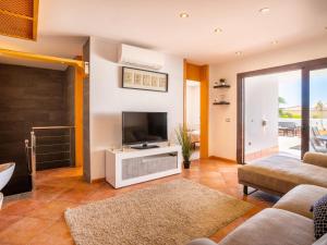 a living room with a flat screen tv and a couch at Paradise Beach - Seaviews - BBQ - Large Terrace - Pool & Pool Bar in Playa Paraiso