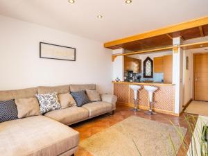 a living room with a couch and a kitchen at Paradise Beach - Seaviews - BBQ - Large Terrace - Pool & Pool Bar in Playa Paraiso