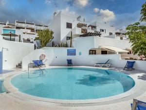 a large swimming pool in front of a white building at Paradise Beach - Seaviews - BBQ - Large Terrace - Pool & Pool Bar in Playa Paraiso