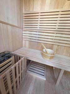 a bowl sitting on a bench in a sauna at Fall Getaway|Crystal Beach Passes|Hottub|FirePit in Fort Erie +72 photos