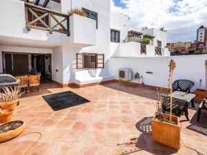 a patio with a table and chairs in a house at Paradise Beach - Seaviews - BBQ - Large Terrace - Pool & Pool Bar in Playa Paraiso