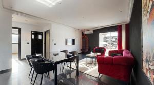 a living room with a red couch and a table at Seven Floors in Tunis