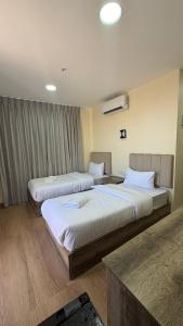 a hotel room with two beds in a room at Selena Hotel Aqaba in Aqaba +19 photos