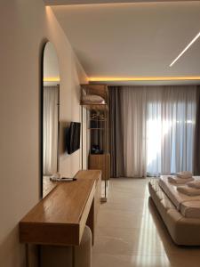 a bedroom with a bed and a large mirror at SunSet Boutique Hotel in Neos Marmaras