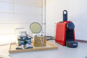 a mirror on a cutting board next to a red heater at In Centro a Rho Fiera Milano e Ospedale Galeazzi in Rho