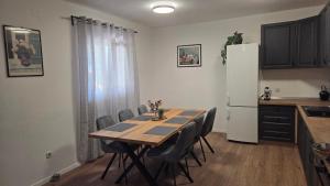 a kitchen with a table with chairs and a refrigerator at Krka Hideaway in Lozovac