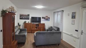 a living room with two couches and a television at Krka Hideaway in Lozovac