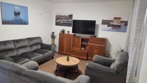 a living room with couches and a flat screen tv at Krka Hideaway in Lozovac