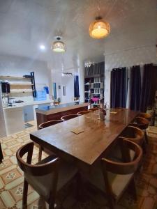 a dining room with a large wooden table and chairs at Nomads Retreat House in Moalboal