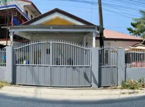 a white fence in front of a house at Nomads Retreat House in Moalboal