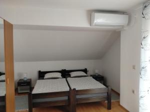 a bedroom with a bed and a white ceiling at Nika in Ogulin