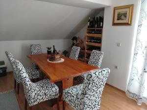 a dining room with a wooden table and chairs at Nika in Ogulin +50 photos