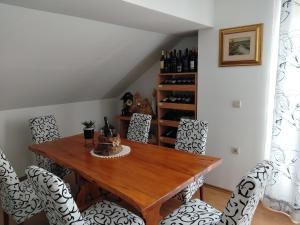 a dining room with a wooden table and chairs at Nika in Ogulin