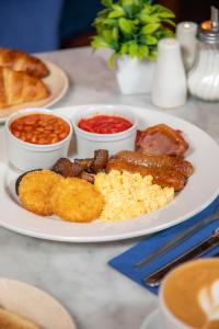 a plate of food with sausage scrambled eggs and beans at The Dixie Dean Hotel in Liverpool