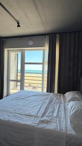 a bedroom with a bed with a view of the ocean at LESS HOTEL Затока in Zatoka