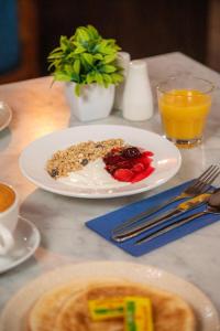 a table with a plate of food and a glass of orange juice at The Dixie Dean Hotel in Liverpool