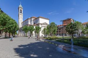 a large building with a clock tower in a city at In Centro a Rho Fiera Milano e Ospedale Galeazzi in Rho