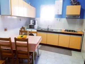 a small kitchen with a table and a sink at Casa do Centro - Alojamento Local in Vieira do Minho
