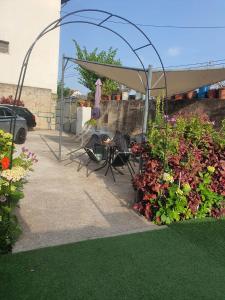 a patio with a table and chairs under a canopy at Casa do Centro - Alojamento Local in Vieira do Minho +9 photos