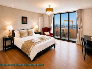 a hotel room with a bed and a desk and a room at CK Serviced Apartments, Titanic Quarter, Belfast in Belfast
