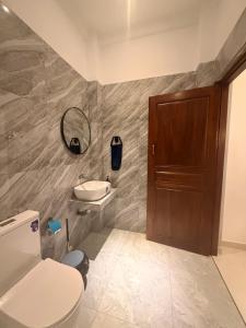 a bathroom with a toilet and a sink at Blue Wings Arugam Bay in Arugam Bay