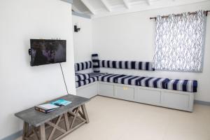 a living room with a couch and a table at Neem View Apartments - Studio in Falmouth