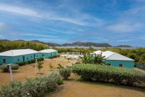 a group of buildings in a field with trees at Neem View Apartments - Studio in Falmouth