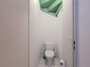 a bathroom with a white toilet in a room at Cottage clim piscine in Saint-Saturnin-lès-Avignon +12 photos