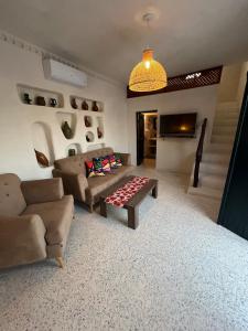 a living room with a couch and a table at Villa Zina s3 in El Mây