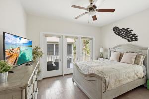 a bedroom with a bed and a ceiling fan at Garden Cottage 89 in Jekyll Island +39 photos