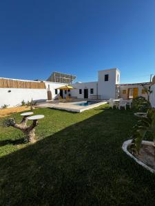 a large yard with a house and a swimming pool at Villa Zina s3 in El Mây