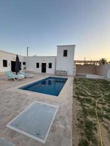 a villa with a swimming pool and a patio at Villa Zina s3 in El Mây +12 photos