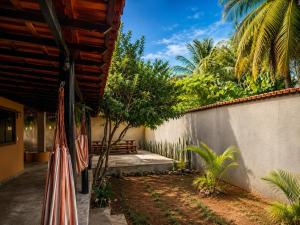 a patio with umbrellas next to a wall at Pousada Refúgio Encantado-Cavernas do Peruaçu in Itacarambi