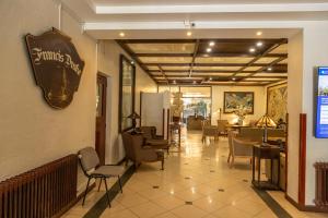 a restaurant with chairs and a sign on the wall at HOTEL LOS NAVEGANTES in Punta Arenas