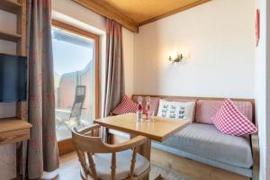 a living room with a couch and a table at Dreimäderlhaus - Das vegetarische Boutique Hotel in Füssen
