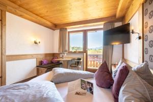 a hotel room with a bed and a balcony at Dreimäderlhaus - Das vegetarische Boutique Hotel in Füssen
