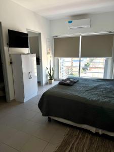 a bedroom with a bed and a large window at Cid Movistar Arena in Buenos Aires