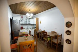a kitchen and dining room with a table and chairs at Kashah Residence in Gjirokastër