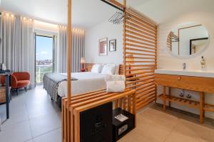 a bedroom with a bed and a sink and a mirror at FONTE SANTA Manor House in Vila Nova de Gaia