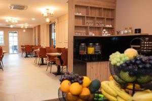 a restaurant with a bunch of fruit on a table at Boutique Hotel Ukus in Tešanj